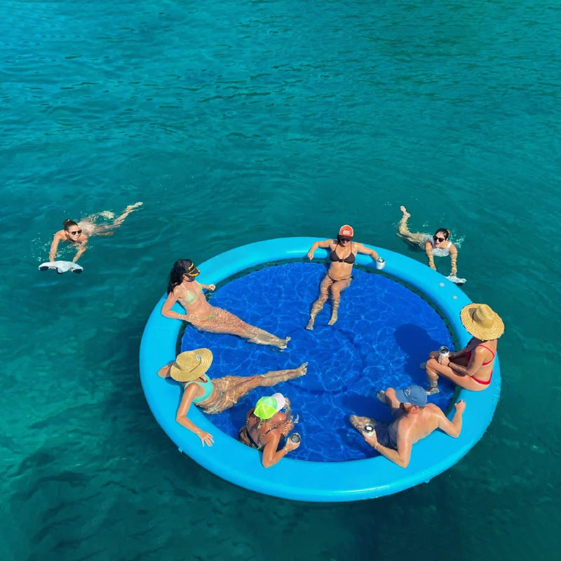 people relaxing on a 2.4m floating ring water trampoline in open water